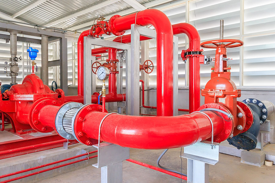 Fire pump set with red suction and discharge pipework, gauges and control valves